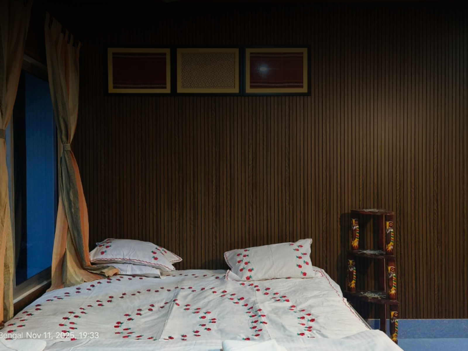 King size bed with embroidered linen in the Deluxe Room