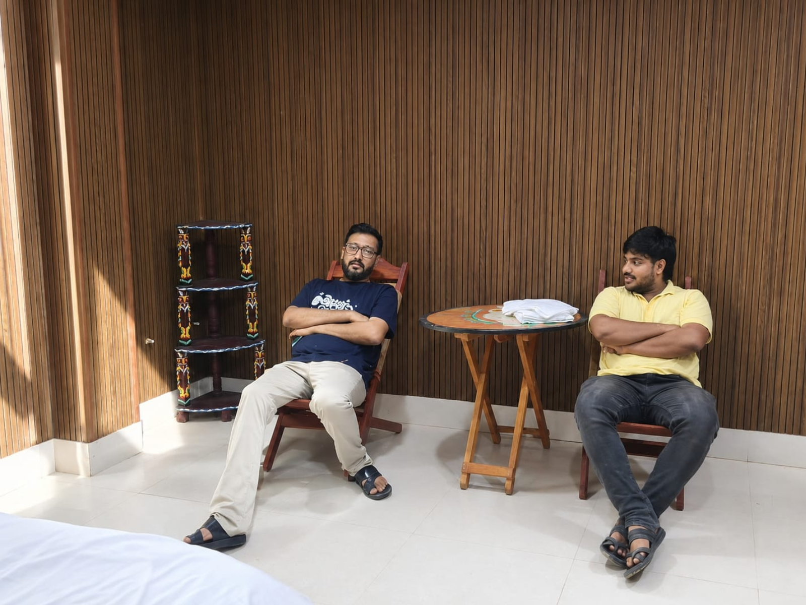 Guests seated in cane chairs at a hand-painted folding table in the Super Deluxe Room